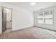 Bedroom featuring a large window for natural light and gray painted doors leading to the bathroom at 2206 Loring Ct, Decatur, GA 30032