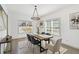 Dining room with a modern chandelier, large windows and table with seating for six, complemented by stylish decor at 2206 Loring Ct, Decatur, GA 30032