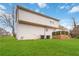 Exterior view of a home with a large lawn, painted brick foundation, and a wooden deck at 2206 Loring Ct, Decatur, GA 30032