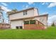 Backyard with an elevated wood deck, green lawn, and view of the two story home at 2206 Loring Ct, Decatur, GA 30032