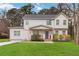 Charming two-story home featuring a covered front porch, blue front door, fresh green lawn, and an inviting curb appeal at 2206 Loring Ct, Decatur, GA 30032