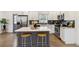 Bright kitchen featuring white cabinets, stainless steel appliances, dark backsplash, and center island with stools at 2206 Loring Ct, Decatur, GA 30032