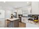 Bright kitchen features white cabinets, stainless steel appliances, a dark backsplash, and a center island with seating at 2206 Loring Ct, Decatur, GA 30032