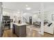 Open concept kitchen with stainless appliances and center island adjoins living room with hardwood floors and natural light at 2206 Loring Ct, Decatur, GA 30032