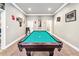 Bright recreation space includes a large pool table with green felt and decorated walls at 1030 Chateau Forest Rd, Hoschton, GA 30548