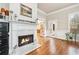 Living room with a fireplace, hardwood floors, and French doors leading to another room at 1030 Chateau Forest Rd, Hoschton, GA 30548