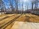 Spacious backyard with mature trees and a partial fence at 122 Sanders Walk, Mcdonough, GA 30252