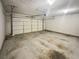 Large two-car garage with an automatic door opener and stained concrete floors at 122 Sanders Walk, Mcdonough, GA 30252