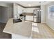 Well-lit kitchen featuring white cabinetry, stainless steel appliances, and a double sink with modern faucet at 122 Sanders Walk, Mcdonough, GA 30252