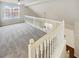 Upstairs loft space with natural light and a white railing at 122 Sanders Walk, Mcdonough, GA 30252