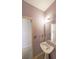 Cozy bathroom features a pedestal sink, vanity mirror, and a soft lilac paint at 2910 Mitchell Ne Cv, Brookhaven, GA 30319