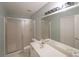 Bathroom featuring double sink vanity, tile floor, and enclosed shower at 2910 Mitchell Ne Cv, Brookhaven, GA 30319