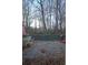 A deck with a table and chairs, covered in leaves, with a view of the trees in the background at 2910 Mitchell Ne Cv, Brookhaven, GA 30319