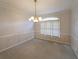 Formal dining room with classic chandelier and large window at 2910 Mitchell Ne Cv, Brookhaven, GA 30319