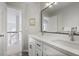 Modern bathroom featuring a double vanity with bright lights and a view toward the stairway at 685 Trailwood Sw Ln, Marietta, GA 30064