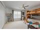 Well-lit bedroom with a bunk bed, storage shelves, and a ceiling fan at 685 Trailwood Sw Ln, Marietta, GA 30064