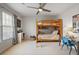 Well-lit bedroom with a bunk bed, storage shelves, a ceiling fan, and an activity desk at 685 Trailwood Sw Ln, Marietta, GA 30064