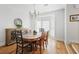 Dining room with a wooden table, elegant sideboard, and natural light from the window creating a cozy atmosphere at 685 Trailwood Sw Ln, Marietta, GA 30064