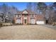 Traditional brick home featuring a two-car garage, mature landscaping and a basketball hoop at 685 Trailwood Sw Ln, Marietta, GA 30064