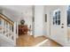 Bright foyer featuring hardwood floors, a staircase with white risers, and natural light from the front door at 685 Trailwood Sw Ln, Marietta, GA 30064