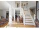 Spacious foyer with hardwood floors, staircase, and views into the living room, providing a welcoming entrance at 685 Trailwood Sw Ln, Marietta, GA 30064