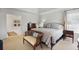 Bright, stylish main bedroom featuring a large bed, sitting area, neutral colors, and an ensuite bath at 685 Trailwood Sw Ln, Marietta, GA 30064