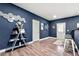 Finished basement featuring a stylish bar area with dark blue walls, light trim, and wood-look flooring at 1353 Wilson Manor Cir, Lawrenceville, GA 30045