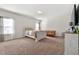 Bright bedroom with neutral paint, carpet floors, and a comfortable sitting area at 1353 Wilson Manor Cir, Lawrenceville, GA 30045