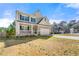 Charming two-story home with neutral siding, blue shutters, and a welcoming front porch at 1353 Wilson Manor Cir, Lawrenceville, GA 30045