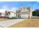 Charming two-story home features a covered porch and well-maintained landscaping at 1353 Wilson Manor Cir, Lawrenceville, GA 30045