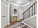 Foyer boasts wood floors, staircase, and a decorative table with rounded mirror at 1353 Wilson Manor Cir, Lawrenceville, GA 30045