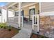 Inviting front porch with stone accents, offering a cozy outdoor seating area at 1353 Wilson Manor Cir, Lawrenceville, GA 30045