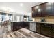 Modern kitchen with stainless steel appliances, granite countertops, and dark wood cabinets at 1353 Wilson Manor Cir, Lawrenceville, GA 30045