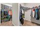 Organized walk-in closet with ample storage including clothing racks, shelves, and plastic storage bins at 1353 Wilson Manor Cir, Lawrenceville, GA 30045