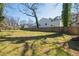 Large, grassy backyard with a fence, offering a blank canvas for landscaping and outdoor enjoyment at 495 Woodlawn Ave, Atlanta, GA 30318