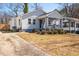 Charming home with a well-maintained lawn, inviting curb appeal, and a long driveway at 495 Woodlawn Ave, Atlanta, GA 30318