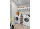 Efficient laundry room with modern washer and dryer and built in wire shelving for storage at 495 Woodlawn Ave, Atlanta, GA 30318