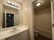 The bathroom features a single sink vanity and a shower-tub combo with white tile at 5488 Wexford Pass, Atlanta, GA 30349