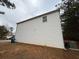 Exterior side view of home with vinyl siding and well-maintained landscaping at 5488 Wexford Pass, Atlanta, GA 30349