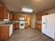 The kitchen features linoleum floors, oak cabinets, white appliances including a dishwasher, oven, and microwave at 5488 Wexford Pass, Atlanta, GA 30349