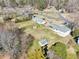 Aerial view of the home with a large backyard and several outbuildings and sheds at 80 Brownsville Ext., Powder Springs, GA 30127