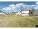 View of the back of this two-story home with a covered patio and large backyard at 80 Brownsville Ext., Powder Springs, GA 30127