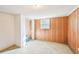 A partially finished basement offers wood paneled walls, a window, and a utility sink in an adjacent room at 80 Brownsville Ext., Powder Springs, GA 30127