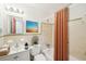 A cozy bathroom features a tiled shower-tub combination, a single sink, and an artistic print on the wall at 80 Brownsville Ext., Powder Springs, GA 30127