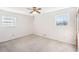 Neutral carpet and walls create a blank canvas in this bright, empty bedroom with ceiling fan and two windows at 80 Brownsville Ext., Powder Springs, GA 30127