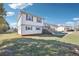 View of the side of this two-story house with a small deck, covered patio and yard at 80 Brownsville Ext., Powder Springs, GA 30127