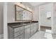 A well-lit bathroom with a double sink vanity and marble floors at 1360 Flora Dr, Conyers, GA 30094