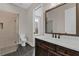 Bathroom featuring a large vanity with a marble countertop and tiled walk-in shower at 1360 Flora Dr, Conyers, GA 30094