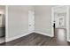 Bright, neutral-toned bedroom featuring wood floors, white trim, an interior door, and a glimpse into the bathroom at 1360 Flora Dr, Conyers, GA 30094