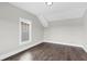 Empty bedroom featuring hardwood floors, one window, and neutral gray paint at 1360 Flora Dr, Conyers, GA 30094